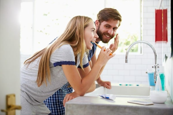 couple brushing teeth