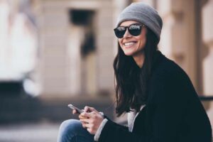 woman with phone smiling